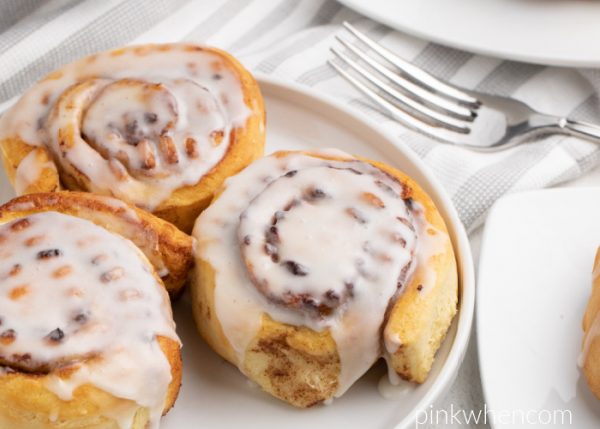 Cinnamon Rolls with glaze and served on a white plate. 