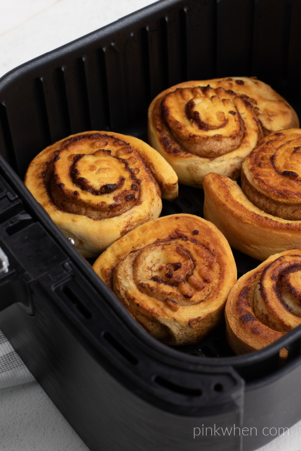 Cinnamon rolls cooked and still in the basket of the Air Fryer.