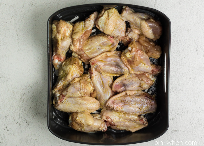 Wings seasoned and ready to cook in the Air Fryer basket. 