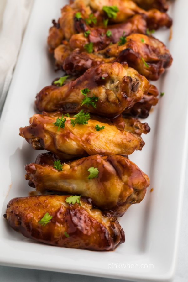 BBQ Chicken Wings made in the Air Fryer and served on a white dish. 