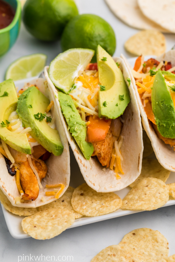 Chicken Fajitas made in the Air Fryer with toppings and surrounded by chips. 
