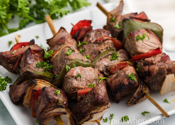 Cooked Air Fryer Steak Kabobs on a white plate and ready to serve. 