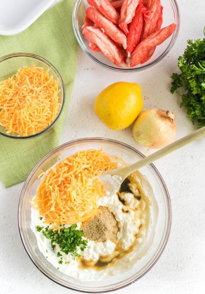 Ingredients in bowls used to make the Hot Crab Dip recipe.