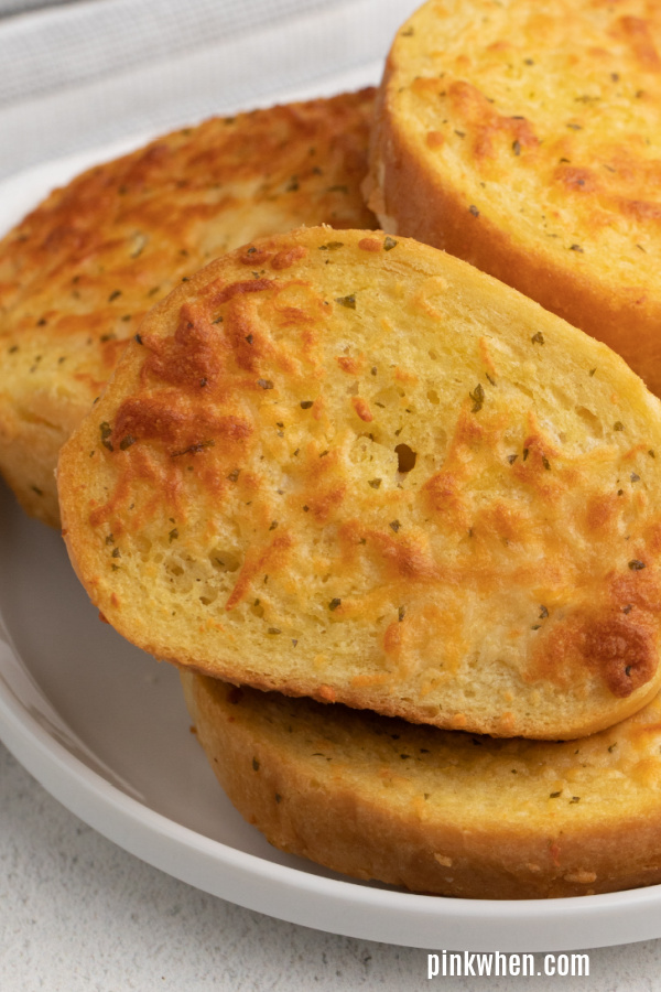 Close up of Air Fryer Cheese Toast on a white plate. 
