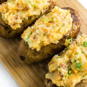Twice Baked Potatoes on a cutting board ready to serve.