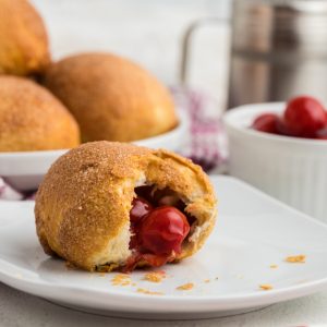Cherry Pie Bomb on a white plate missing a bite.