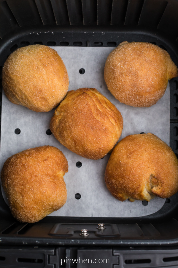 Air Fryer Apple Pie Bombs in the basket of the air fryer after being cooked. 