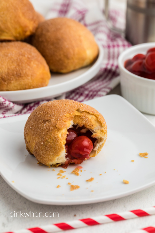 Cherry Pie Bomb missing a bite - on a white plate.