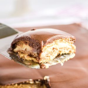 Slice of no bake chocolate eclair cake on a spatula.