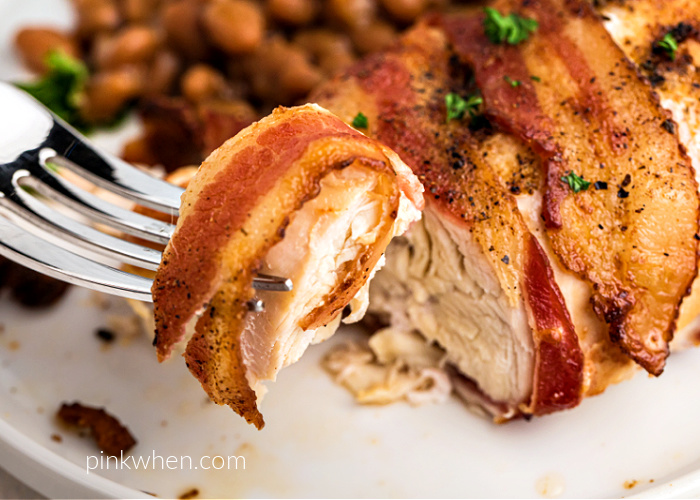 Up close bite shot of air fried bacon wrapped chicken. 