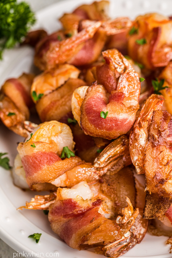 Air Fried Bacon wrapped shrimp on a white plate ready to eat. 