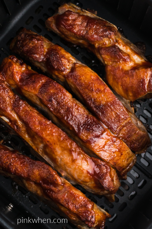 fully cooked air fryer country-style ribs in the basket of the air fryer. 