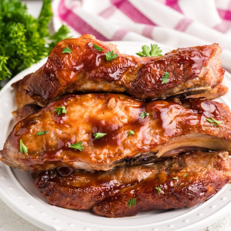 close up photo of air fryer country style ribs on a white plate ready to eat.