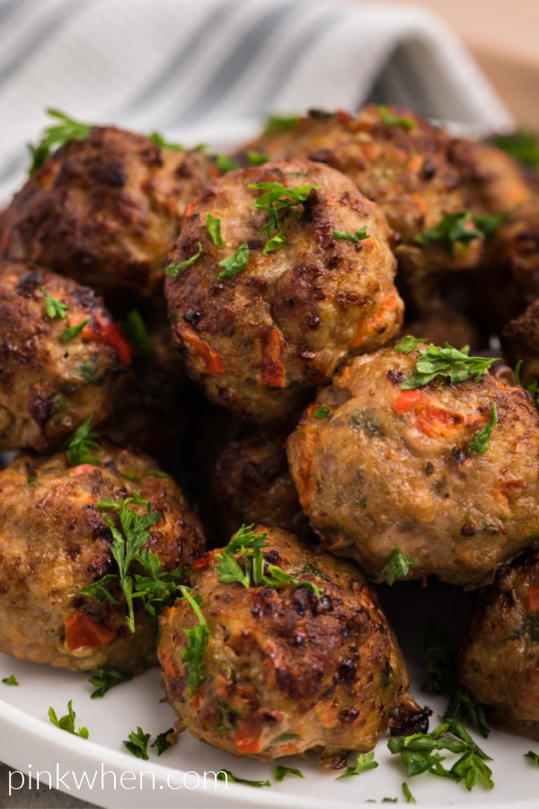 Air Fried Turkey meatballs on a white plate and garnished with fresh parsley. 