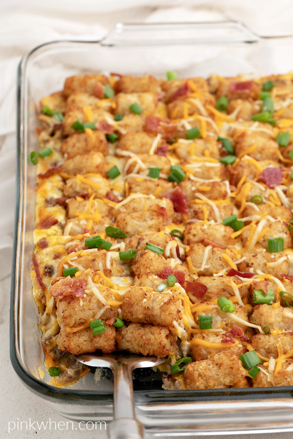 Scoop of bacon cheeseburger tater tot casserole being removed to eat. 