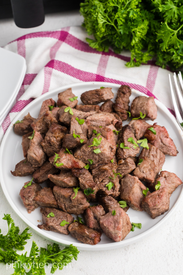 Garlic Butter Steak Bites on a white plate ready to serve. 