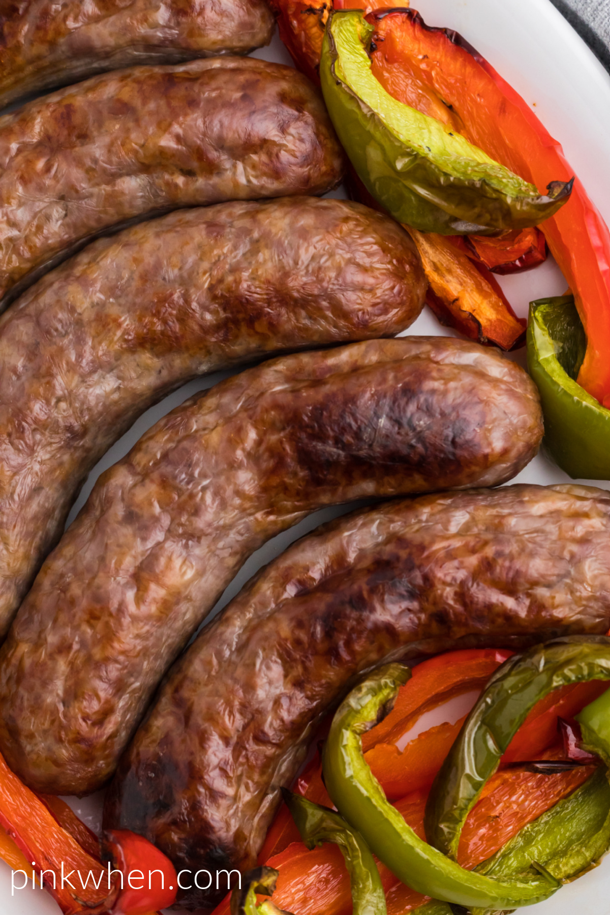 Close up photo of brats and peppers made in the air fryer and ready to eat. 