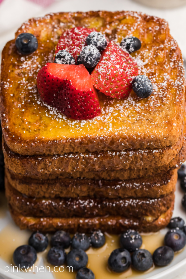 Air Fried French Toast topped with fresh strawberries, blueberries, confectioners' sugar, and real maple syrup. 
