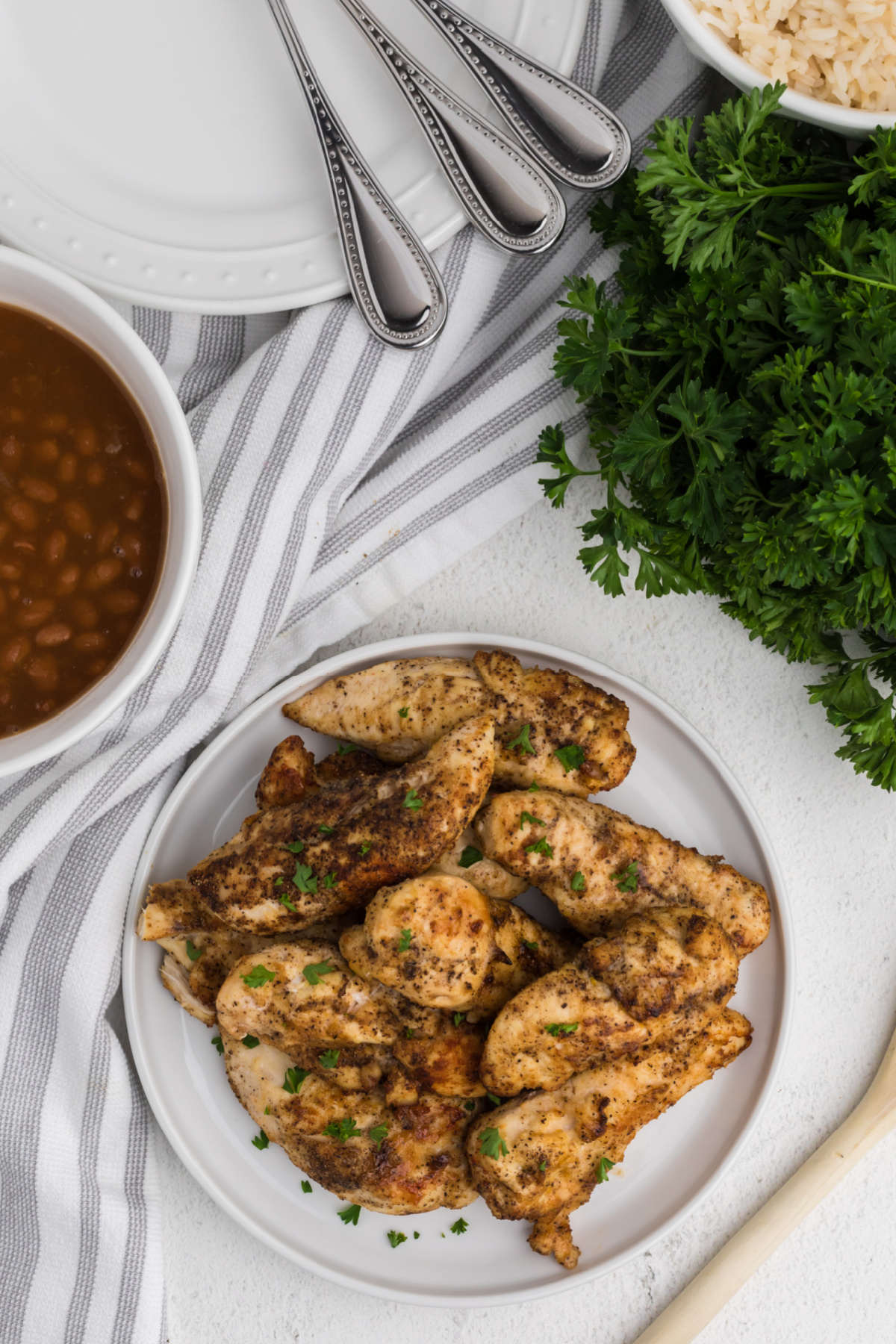 Air Fryer Grilled Chicken Tenders on a a white plate. 