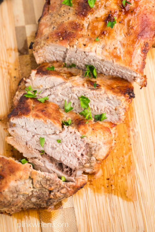 Pork Tenderloin sliced on a cutting board. 