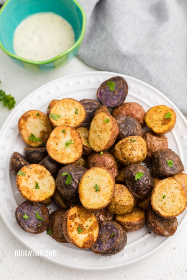 Roasted potatoes made in the air fryer on a white plate. 