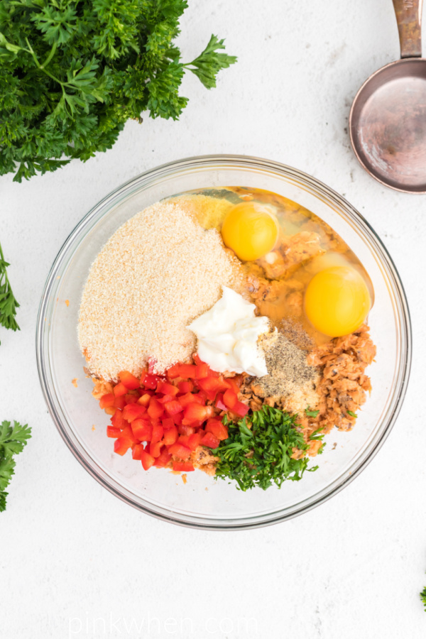 Ingredients in a mixing bowl that are needed for Air Fryer Salmon Patties. 