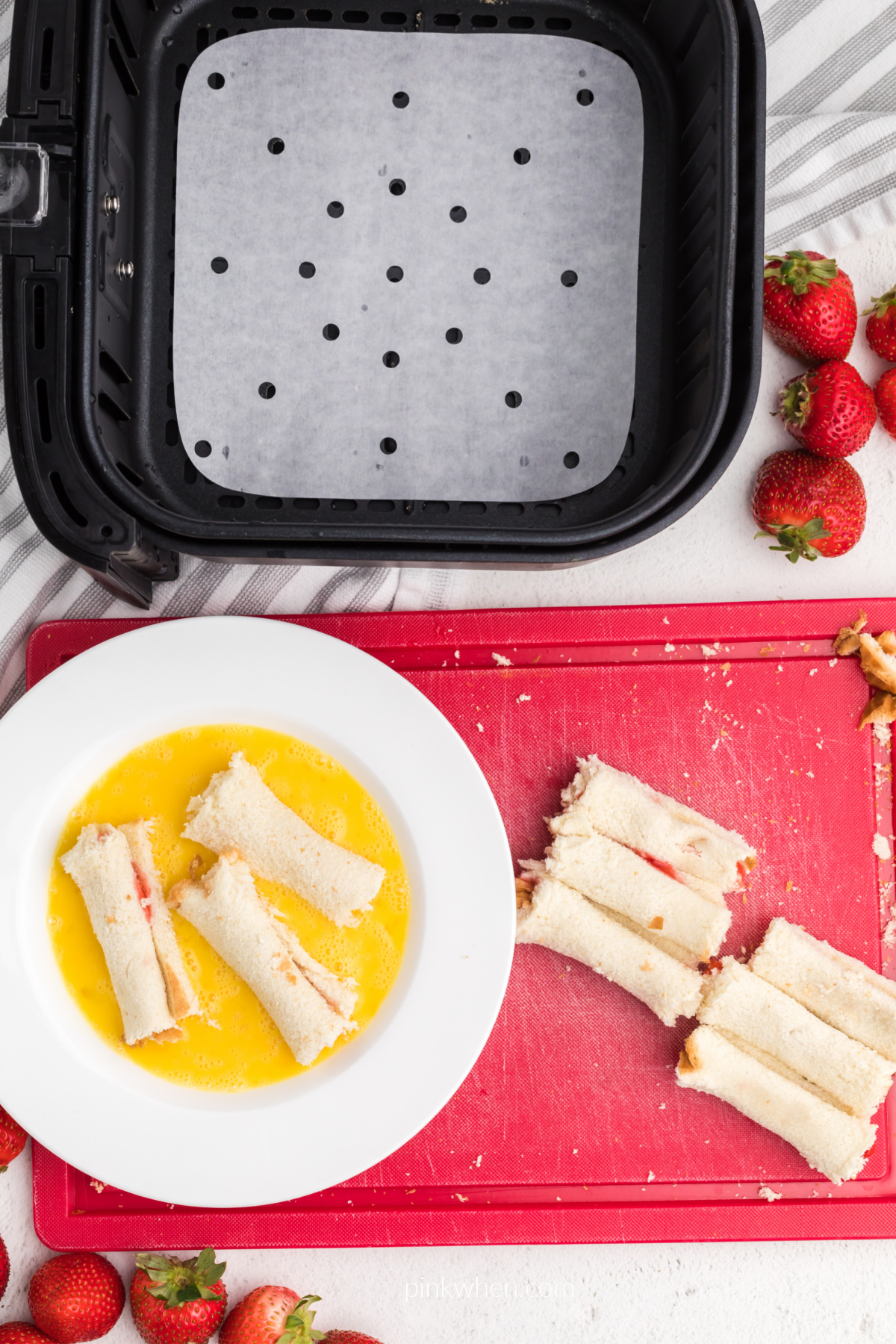 French toast roll ups being dipped into the egg mixture. 