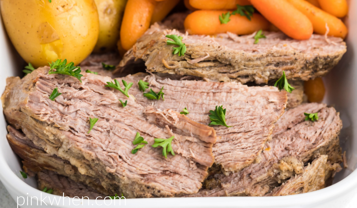 Close up photo of Instant Pot Tri Tip sliced and served with potatoes and carrots and topped with fresh parsley. 