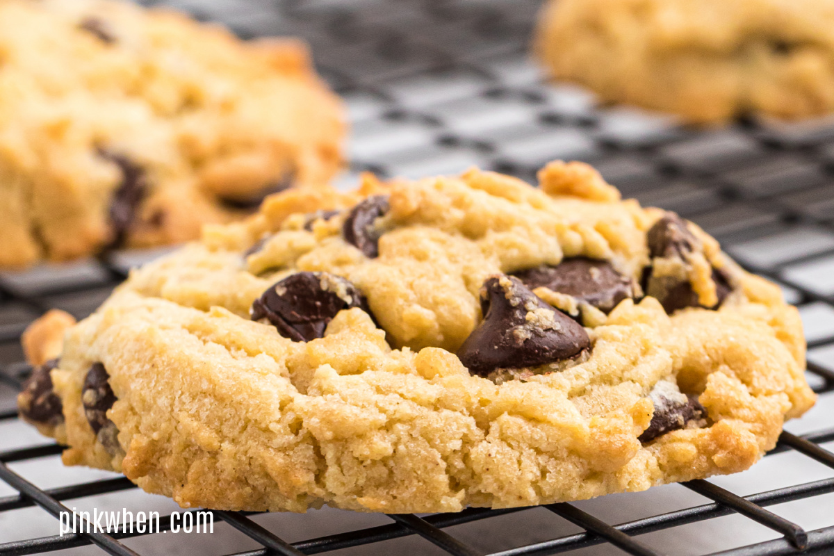 Chocolate chip cookie on a wire rack cooling after being baked in the air fryer. 