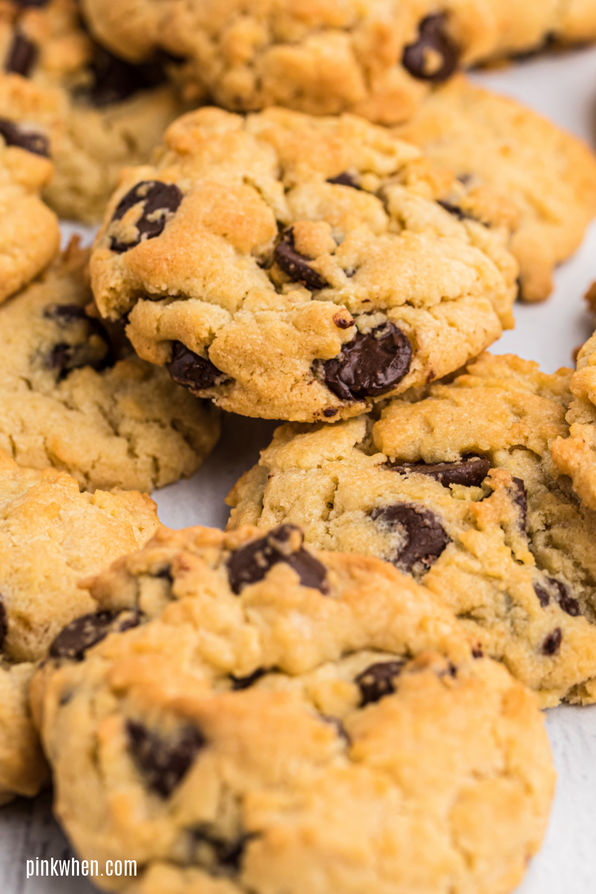 Stack of air fried chocolate chip cookies on a white table. 