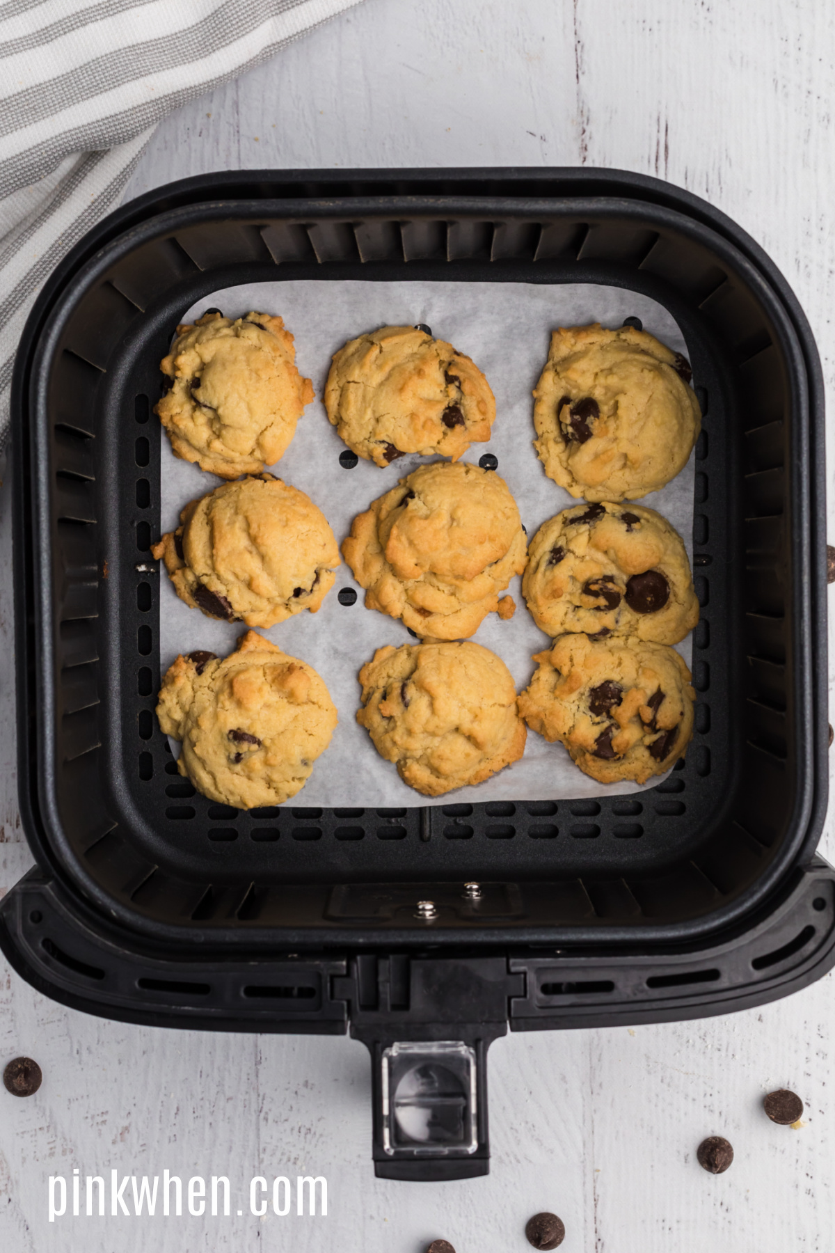 Cookies fully cooked in the basket of the air fryer.