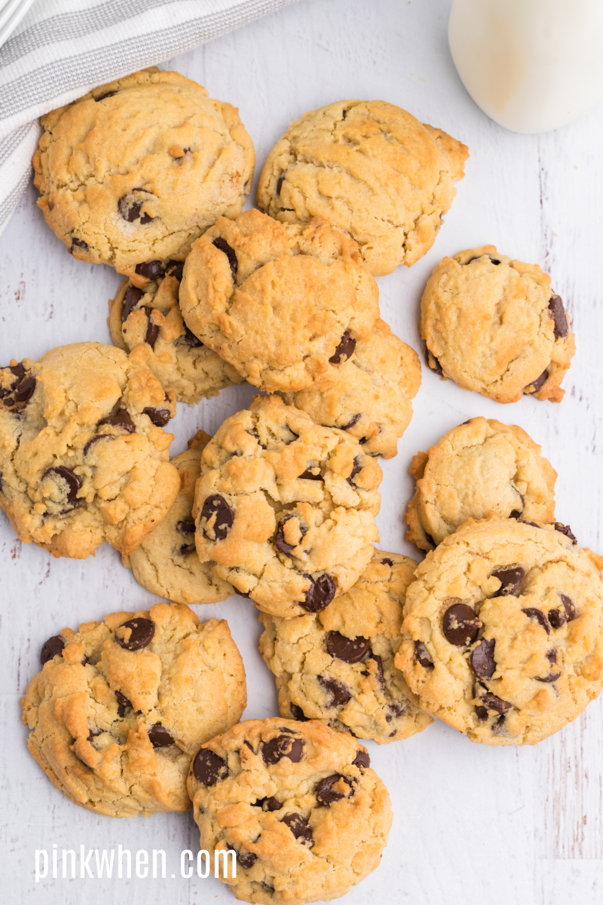Overhead shot of chocolate chip cookies on a white table that were made in the air fryer.