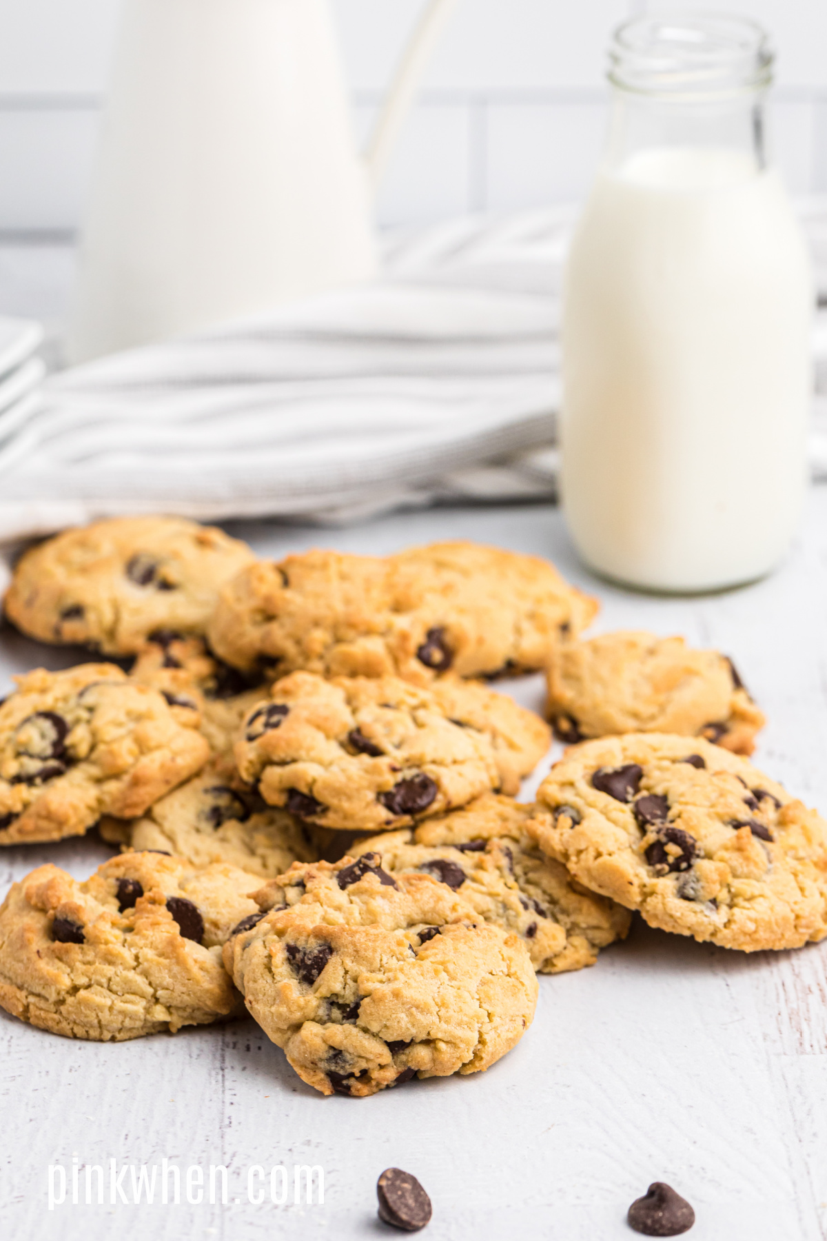 Air Fryer Chocolate Chip Cookies on a table with milk, ready to eat. 