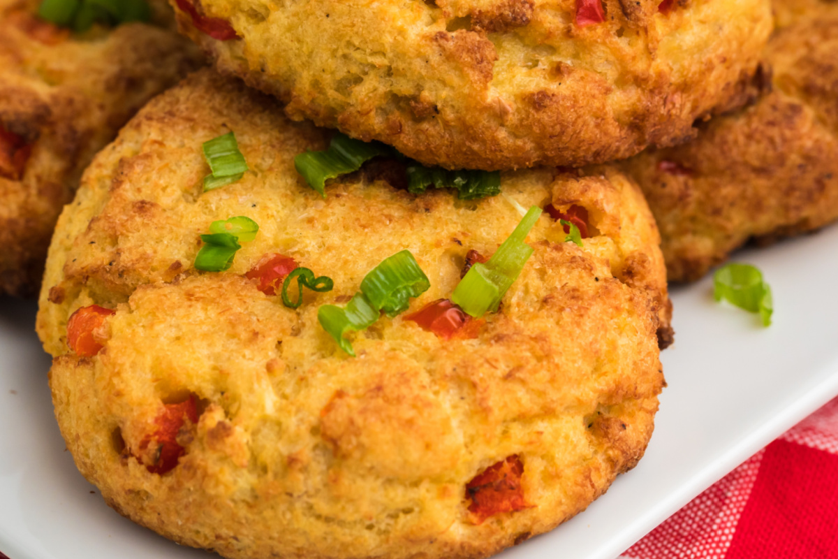 Cooked air fryer crab cakes on a white plate ready to serve.