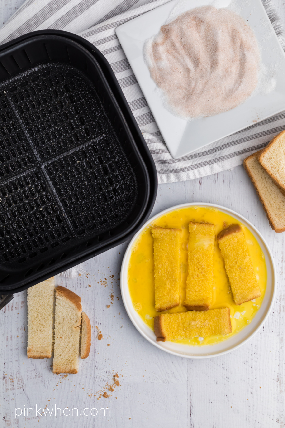 French toast sticks dipped into egg before being added to cinnamon and sugar mixture and placed into the air fryer. 