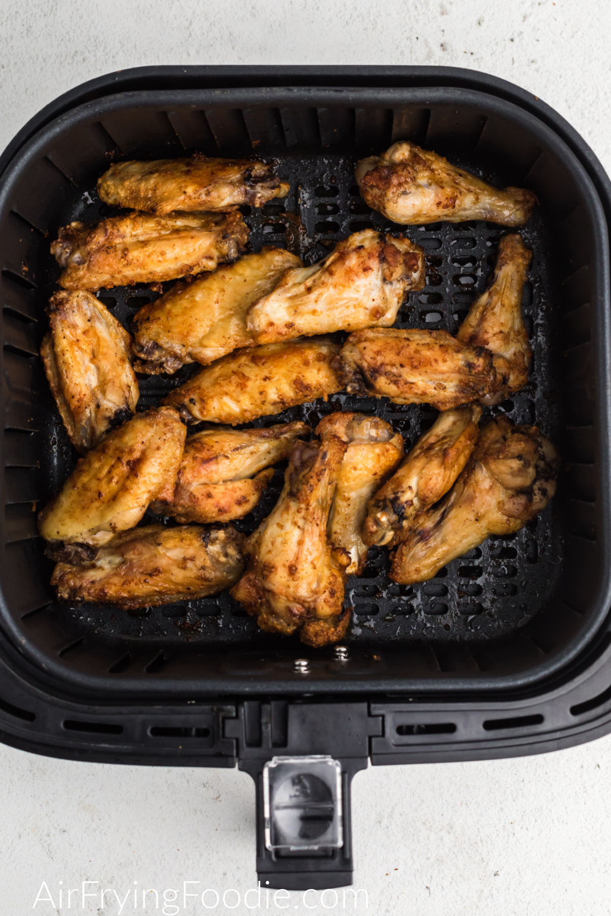 Air Fryer Garlic Parmesan Chicken Wings in the basket of the air fryer. 