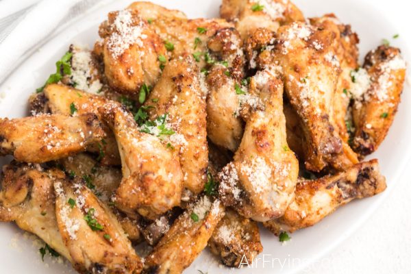 Garlic parmesan chicken wings on a plate.