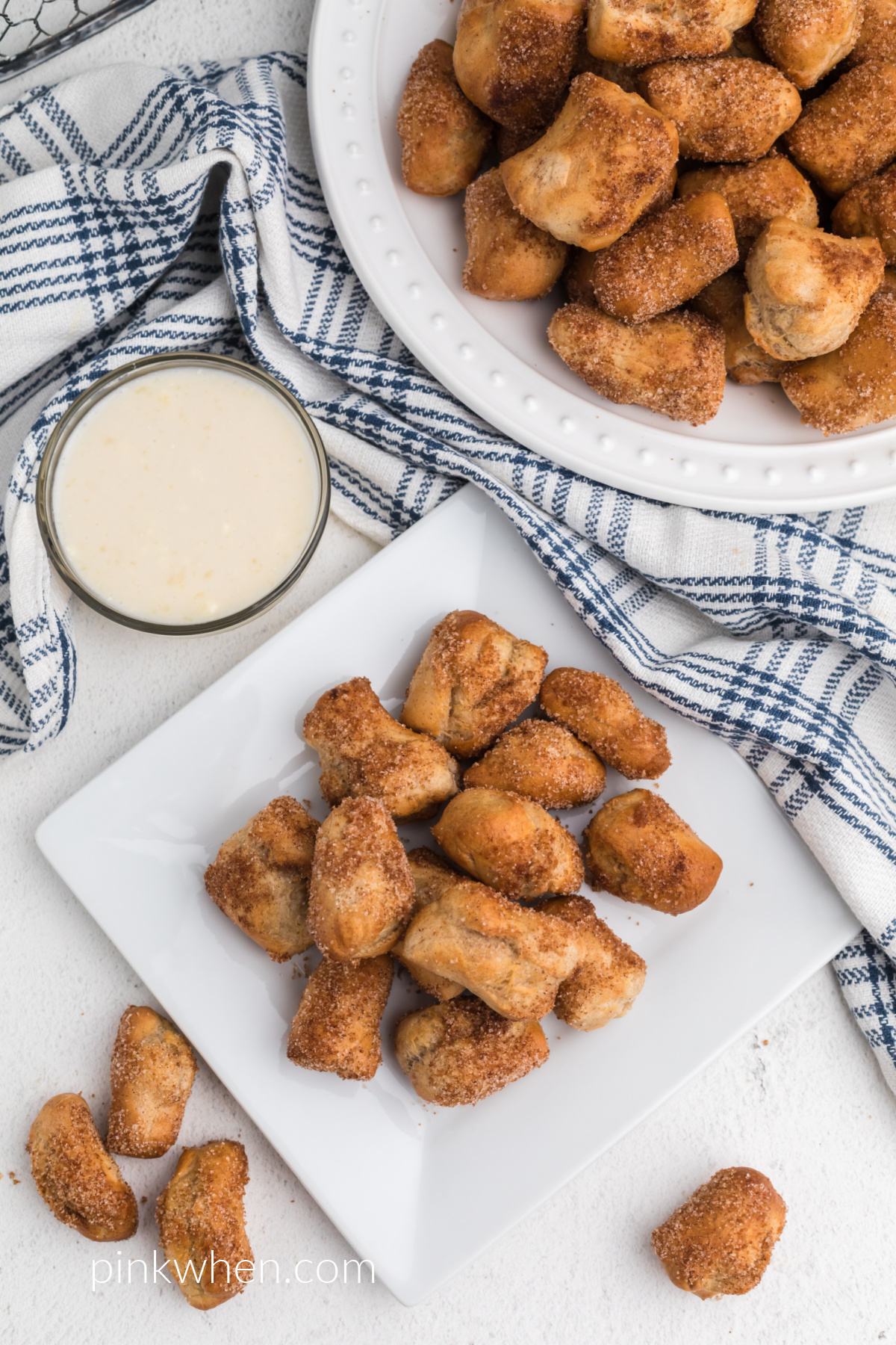 Overhead shot of plates of cooked Air Fryer Pretzel Bites rolled in cinnamon and sugar. 
