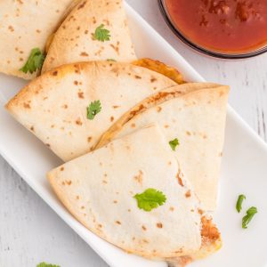 Overhead photo of quesadillas that wewre made in the air fryer with a side of salsa.