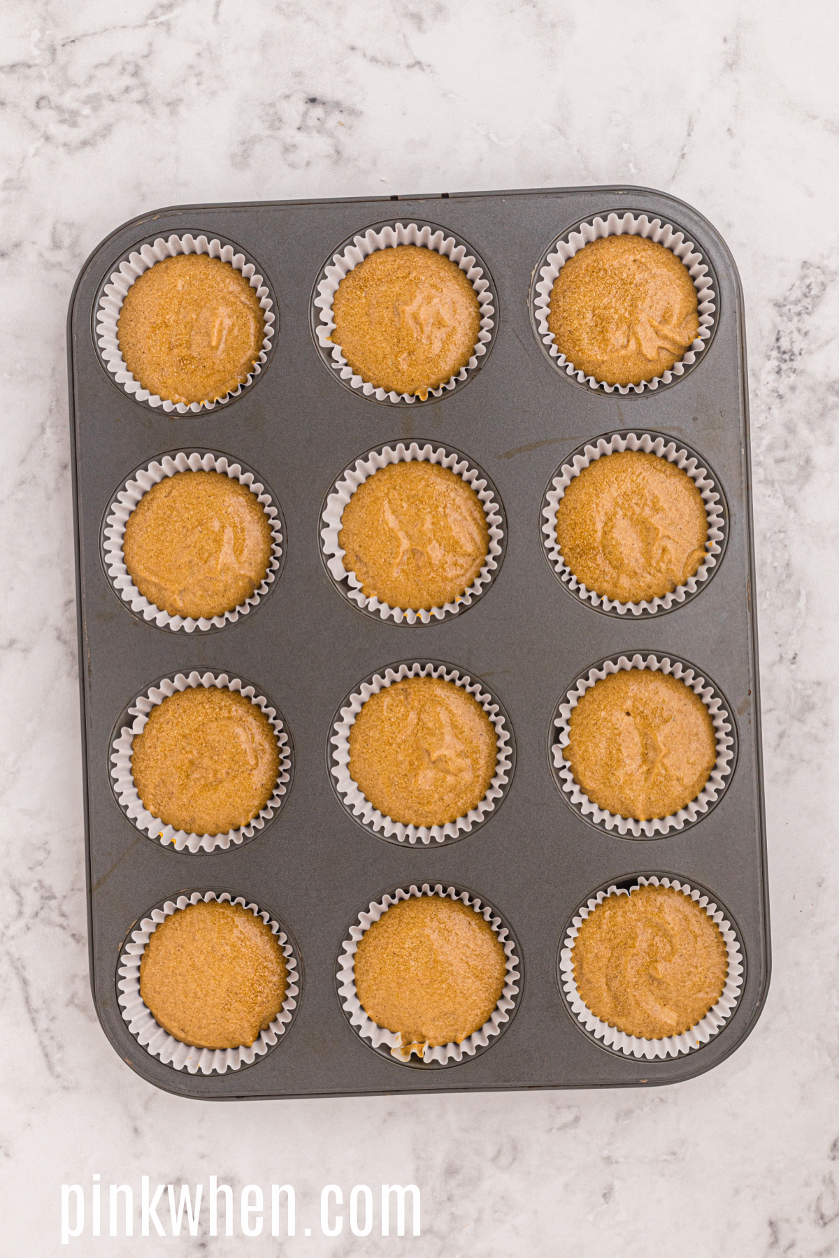 Gingerbread cupcakes in a cupcake tin ready to cool and then top with cream cheese frosting. 