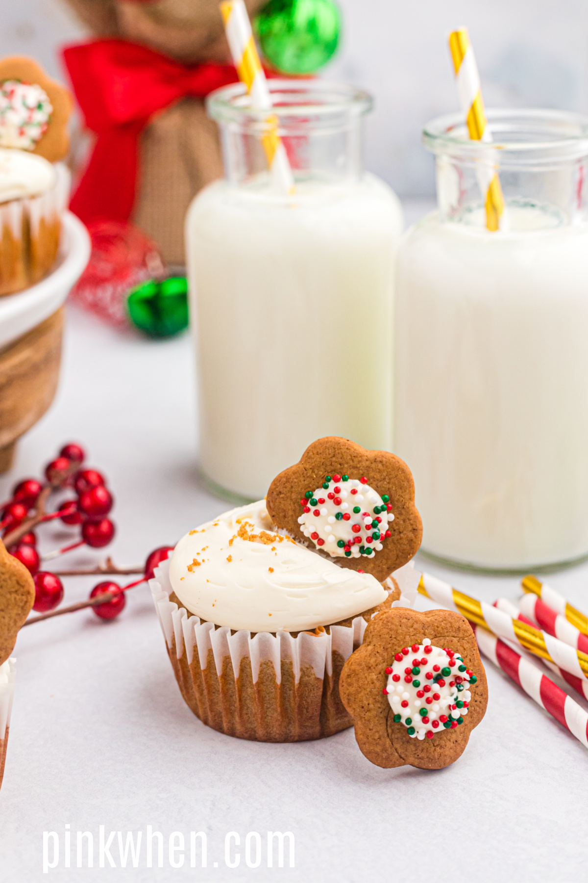 Gingerbread cupcake on a table with cookies and glasses of milk. 