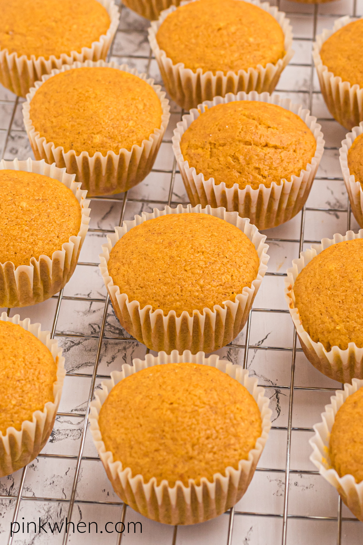 Pumpkin Spice Cupcakes on a wire cooling rack. 