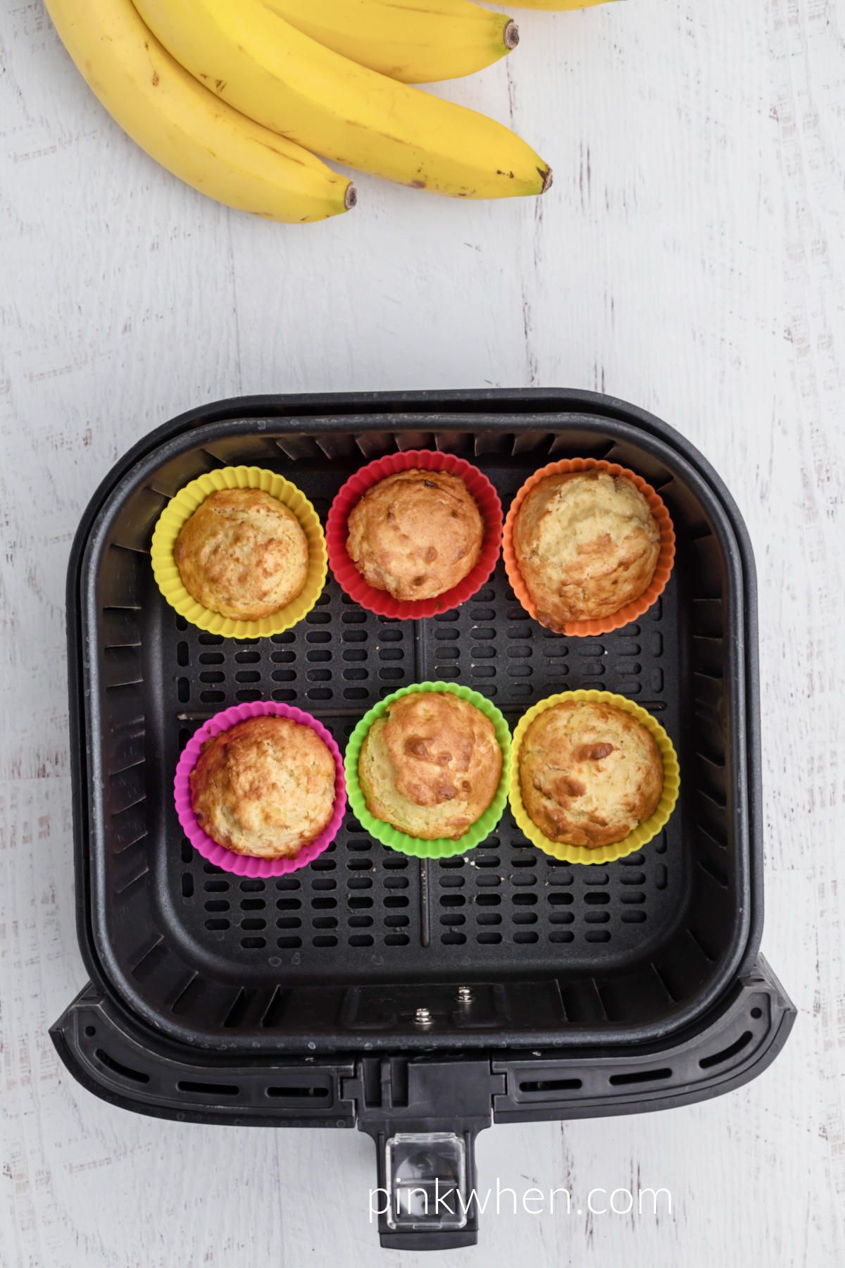 Baked banana muffins in the basket of the air fryer. 