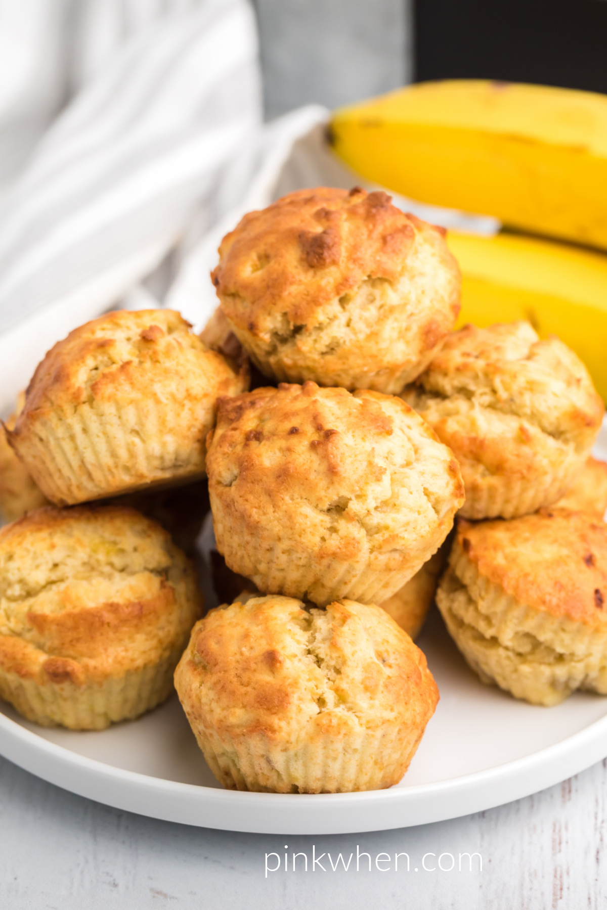 Large plate full of air fryer banana muffins ready to serve. 