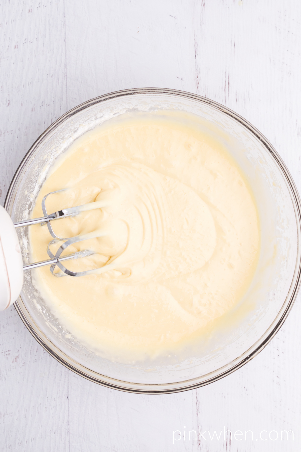 Cake mix in the bowl along with a handmixer on the side. 