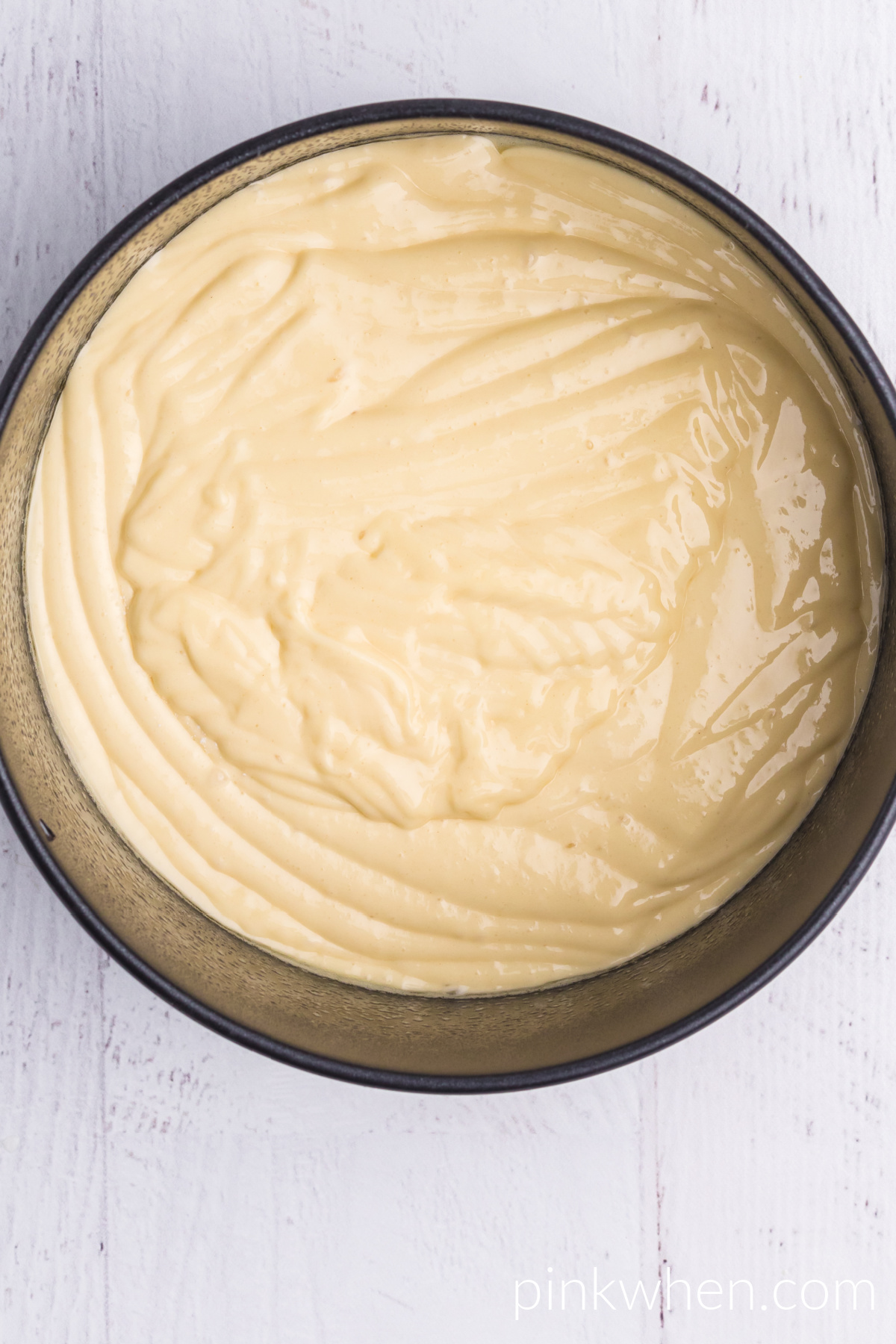 Cake batter poured into an air fryer safe pan. 