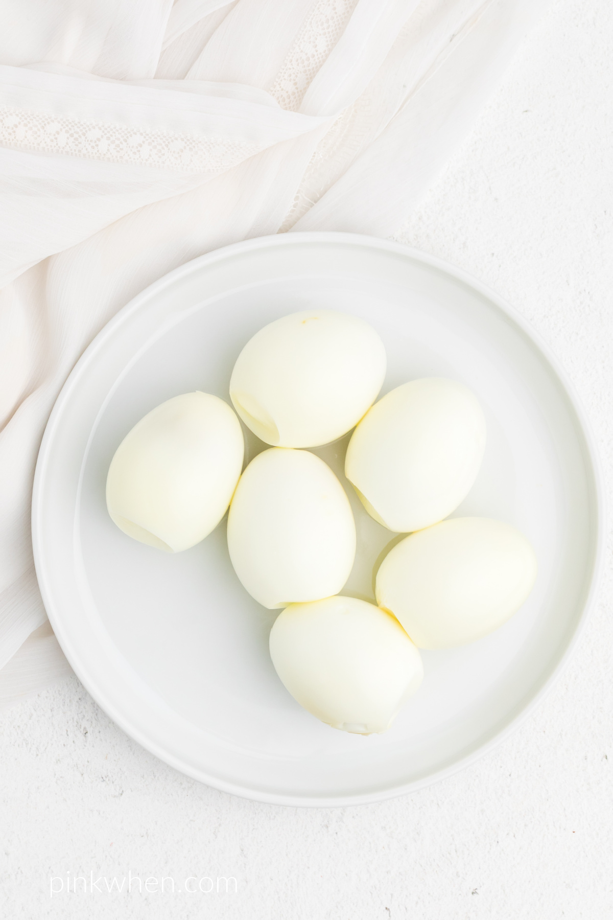 Eggs that have been peeled after being soaked in a ice bath and after cooking in the air fryer.