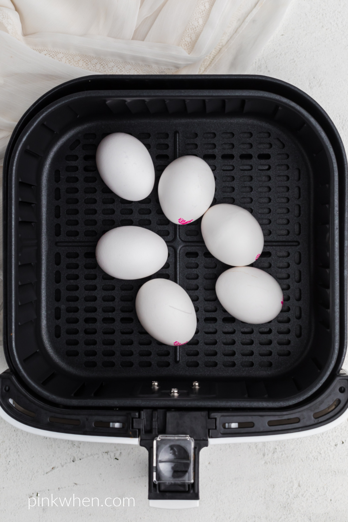 6 eggs in the basket of the air fryer. 