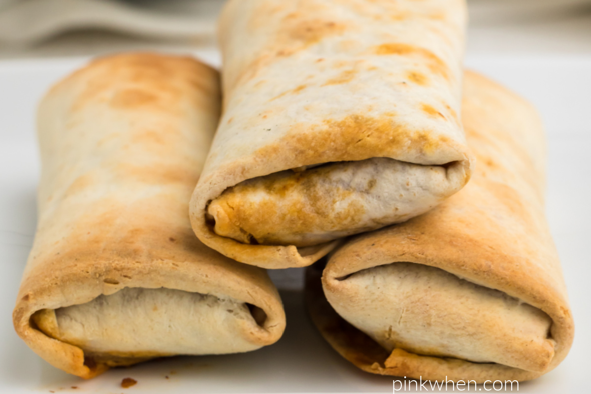 Stacked cooked burritos that were cooked in the air fryer. 