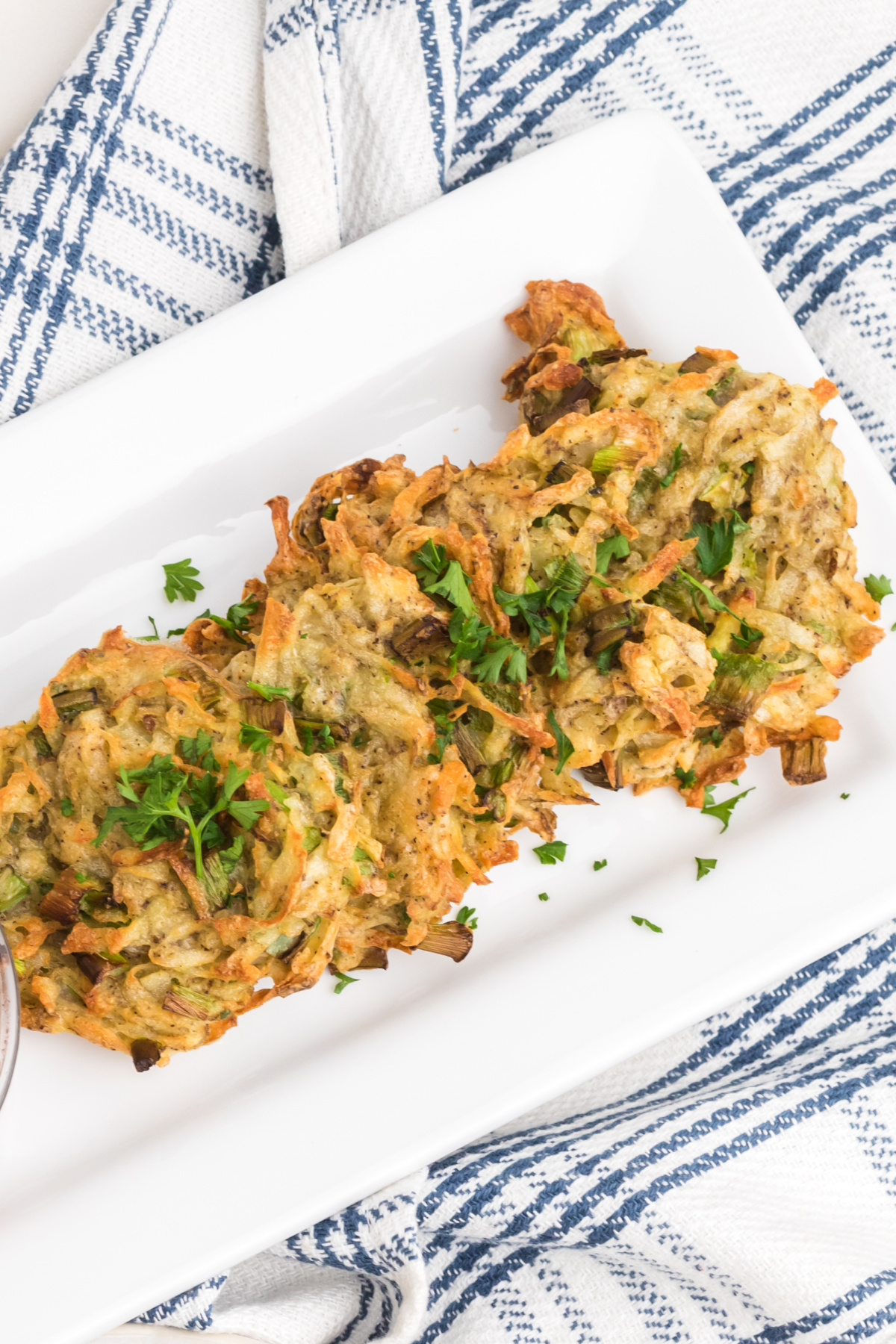 Potato fritters stacked on a plate ready to serve.